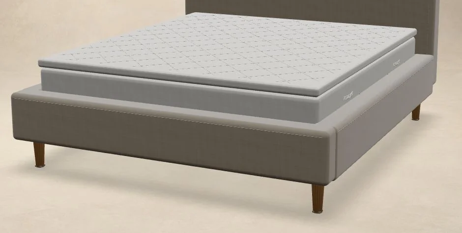Close view of the mattress and quilted topper above the upholstered bed frame